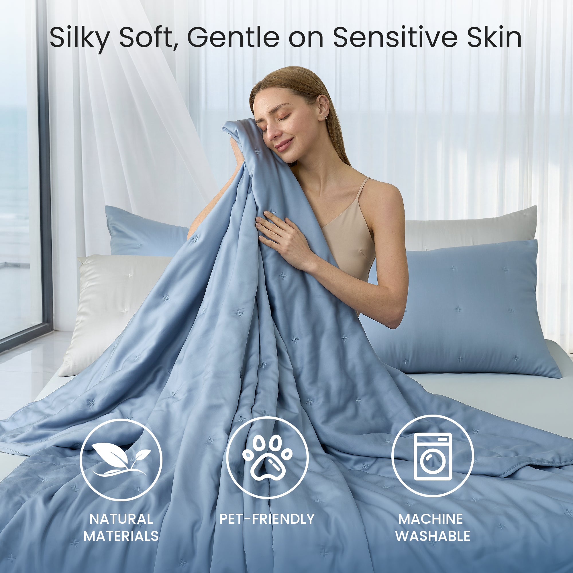 A woman wrapped in Snuggle Sac Cooling comforter sitting on the bed proving Silky Soft, Gentle on sensitive skin#color_Blue