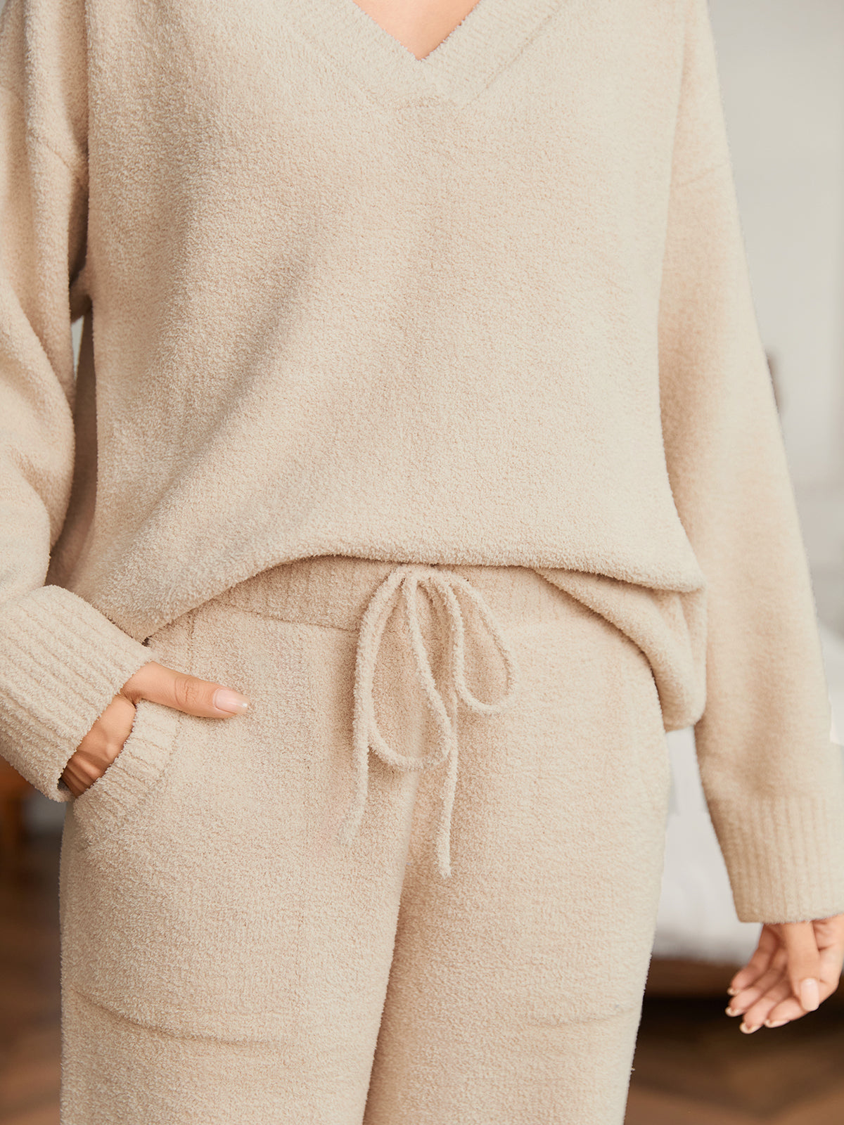Close up of women long sleeve V-neck knit loungewear set in Beige, showcasing drawstring waist and soft knit fabric #color_Beige