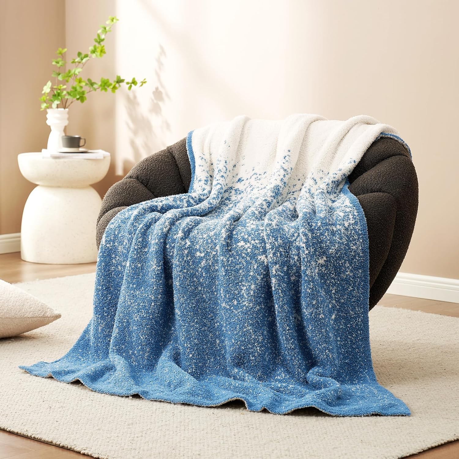 Snuggle Sacs Reversible Ombre Heather Feather Yarn Knit Throw Blanket on a grey couch#color_Blue
