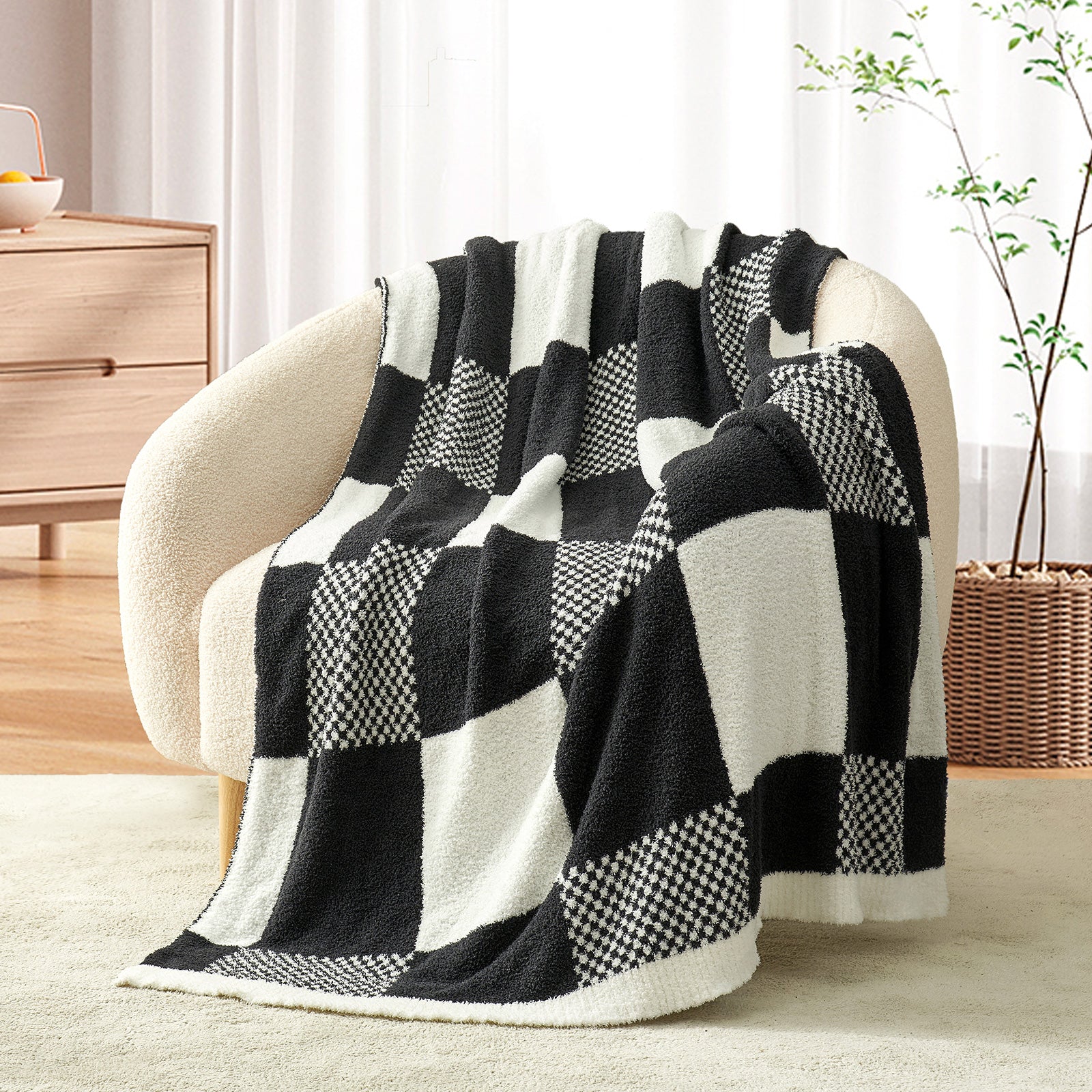 Black and white checkered blanket draped over a chair in a room with a plant and wooden furniture. #color_Black White