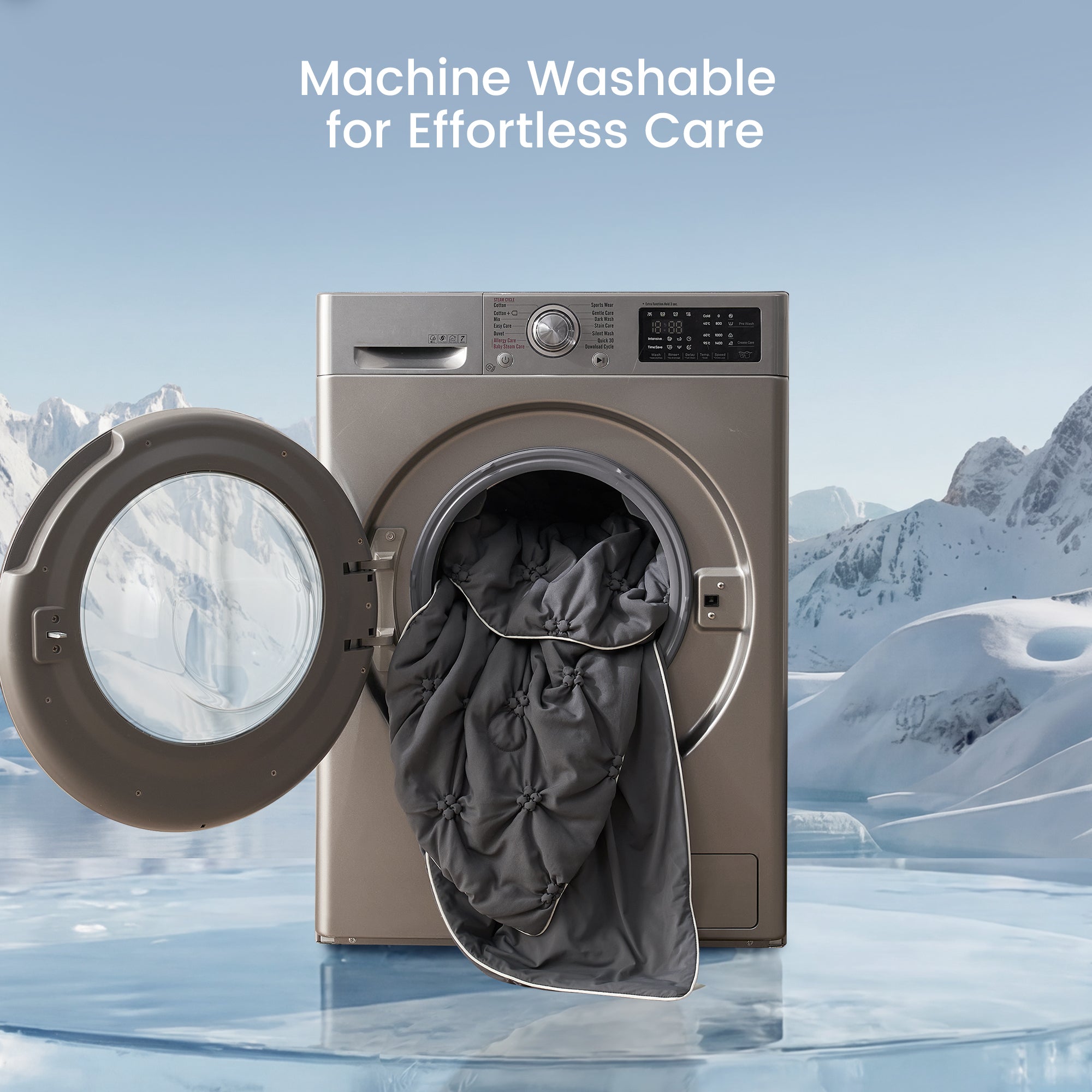 Washing machine with open door showing a gray comforter inside, set against a snowy mountain landscape.#color_Charcoal Grey