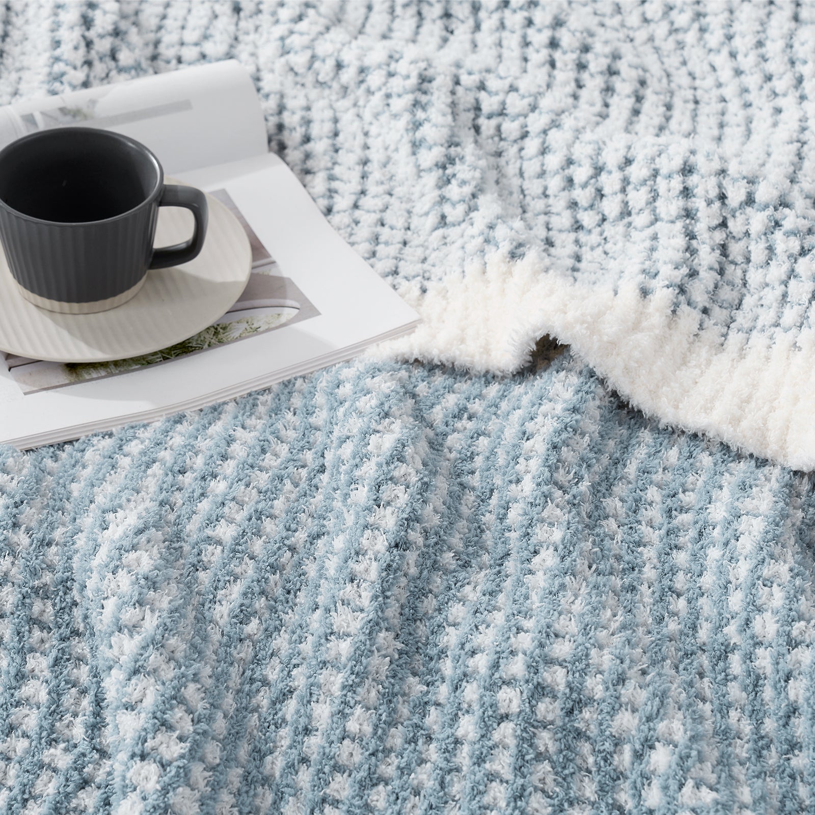 Close up of blue blanket with a mug and magazine#color_Cream/Blue