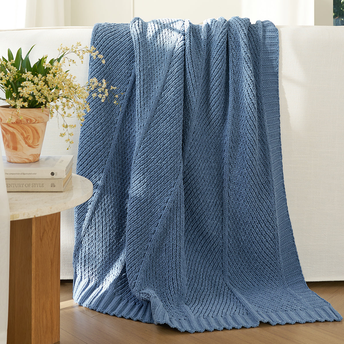 Chevron chenille knit throw blanket in Blue draped over a sofa creating a warm and inviting look #color_Blue