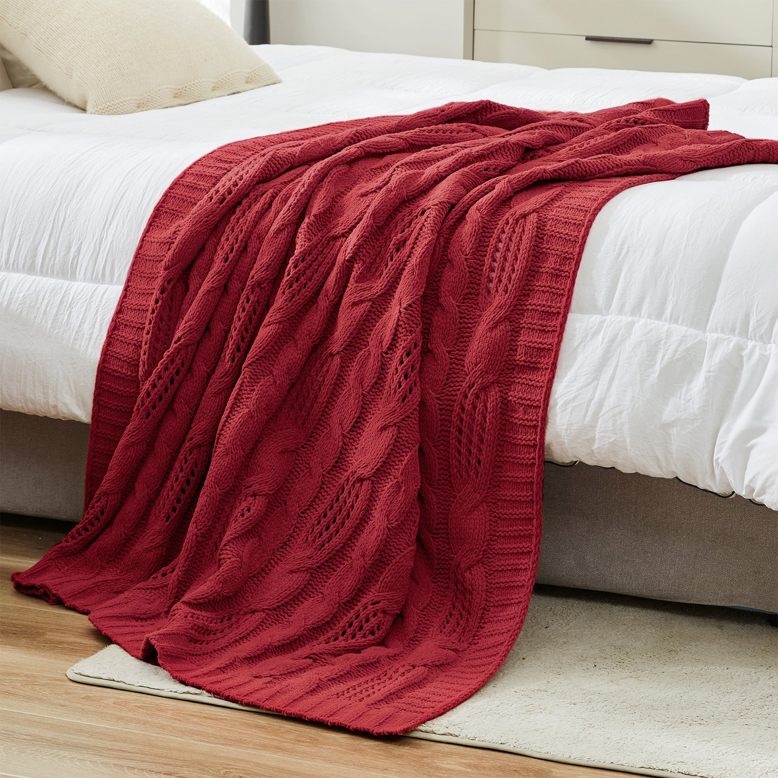 Cable chenille knit throw blanket in Red layered on a bed creating a warm and cozy bedroom look #color_Red
