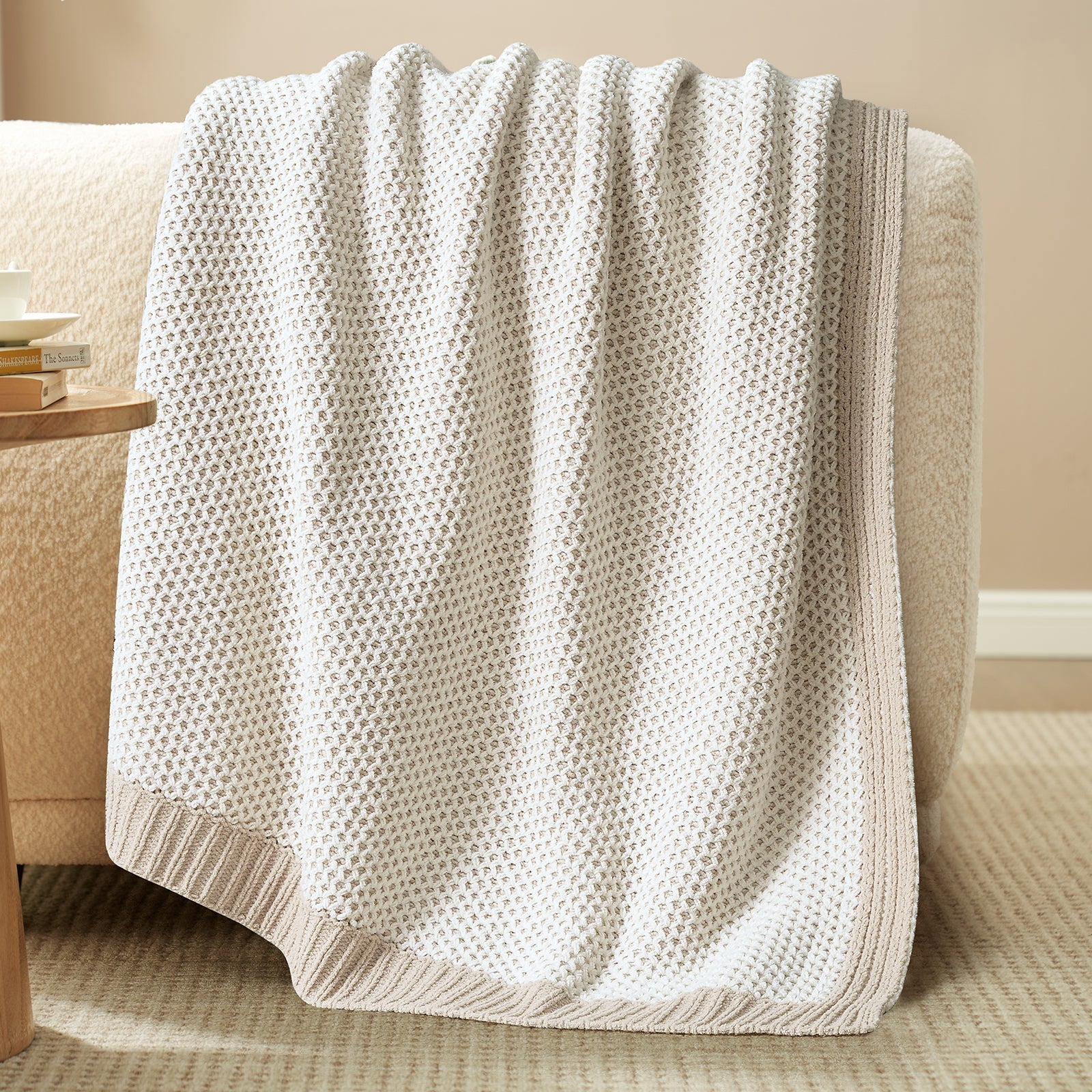 Beige textured blanket draped over a beige armchair in a cozy living room setting. #color_Khaki&White