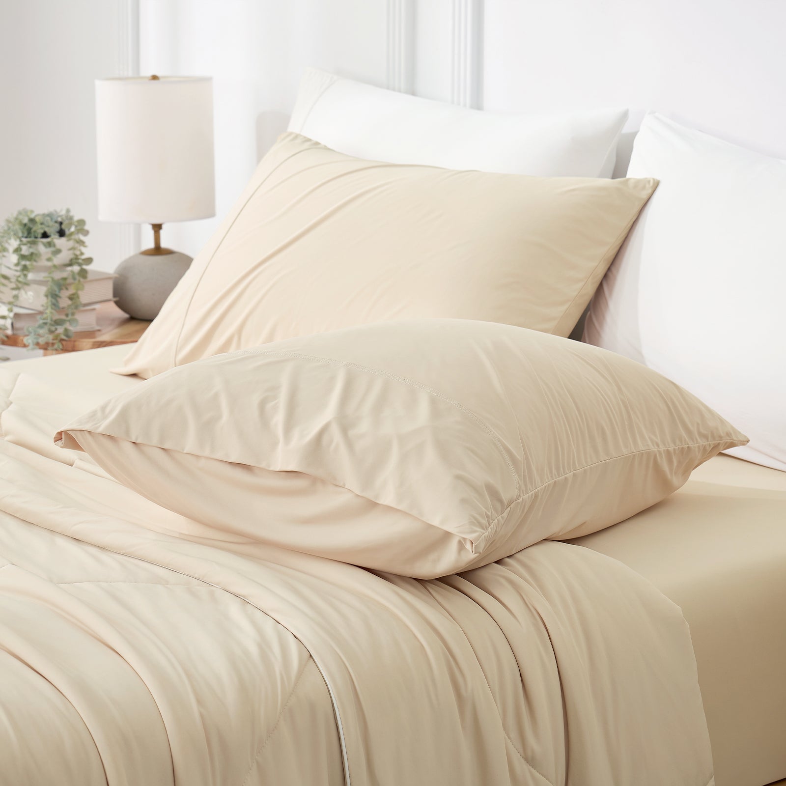 Snuggle Sac Khaki cooling pillows on a bed in a bedroom setting.#color_Khaki