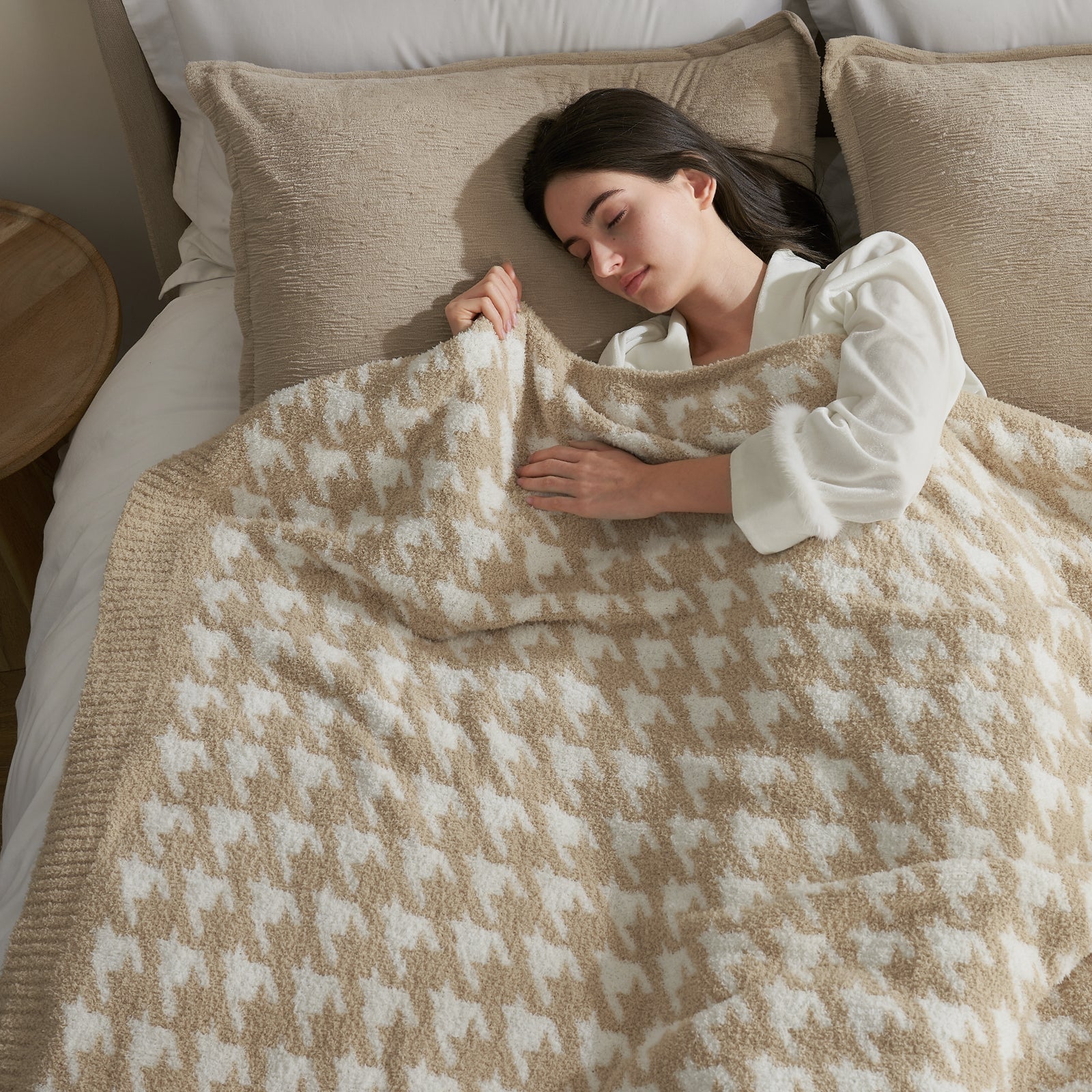 Woman lying in bed under a patterned blanket #color_Beige