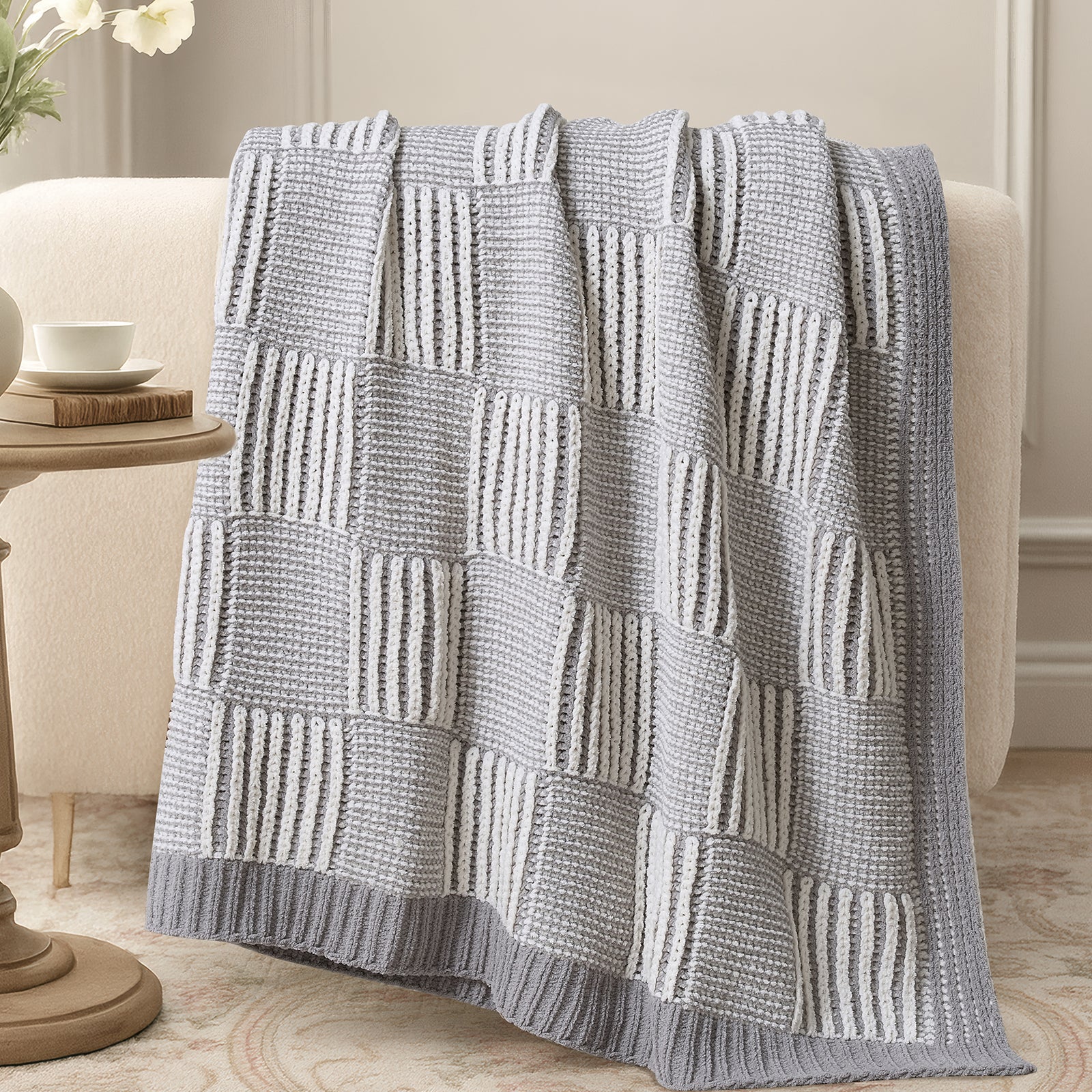 Two tone checkered chenille knit throw blanket in Gray draped over sofa creating a warm and inviting look #color_Gray