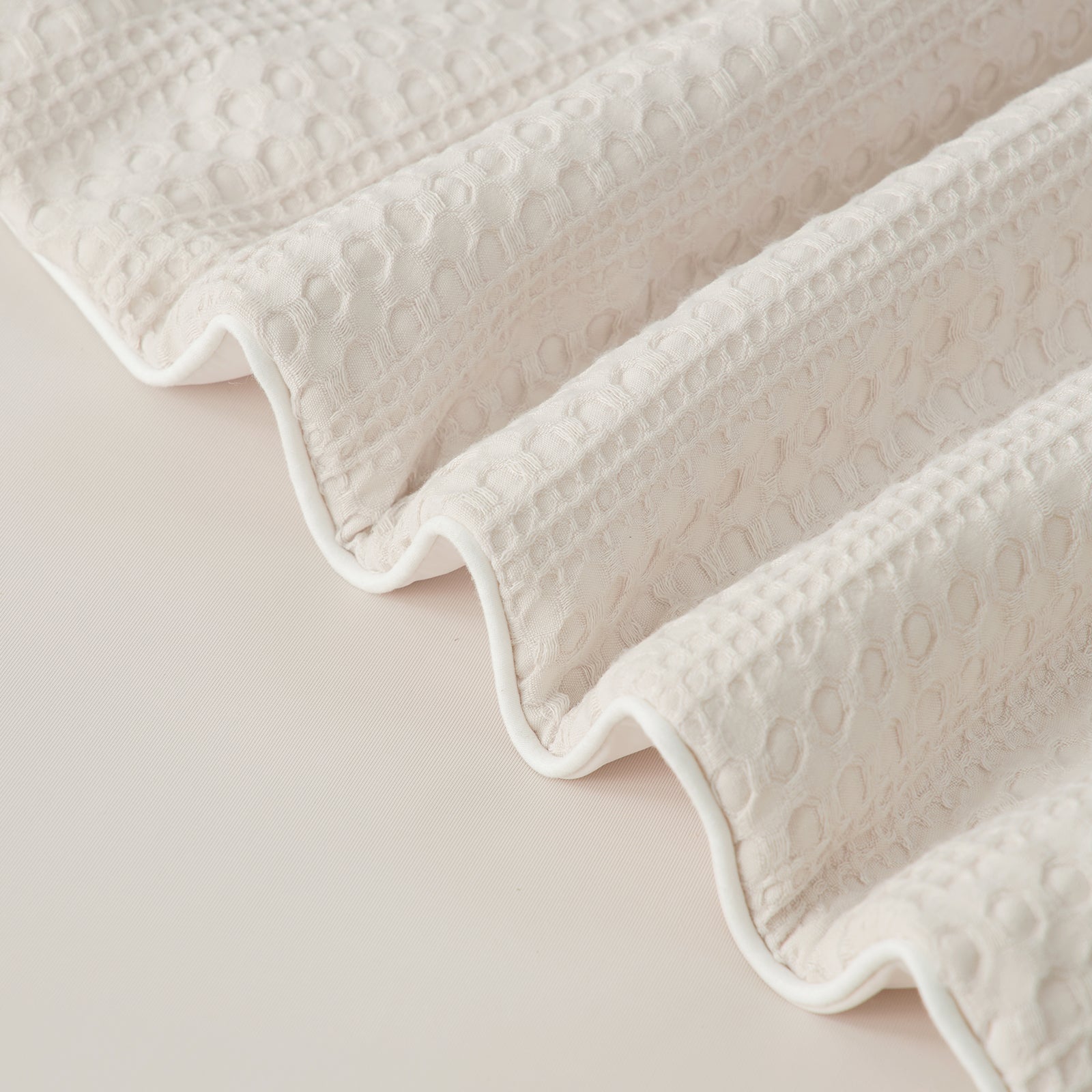close up of Snuggle Sac Natural Fiber Waffle Cooling Comforter edges #color_Beige