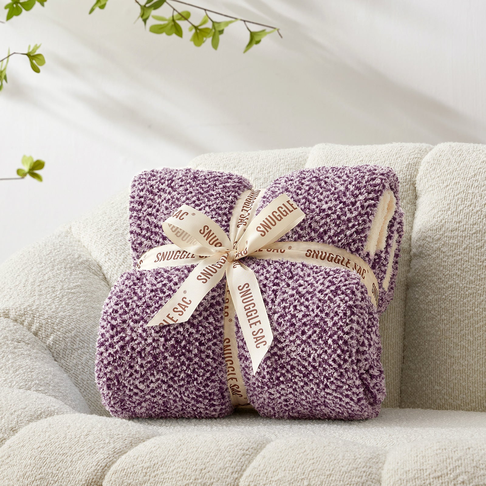 Purple snuggie with a decorative bow on a beige couch #color_Heather Purple