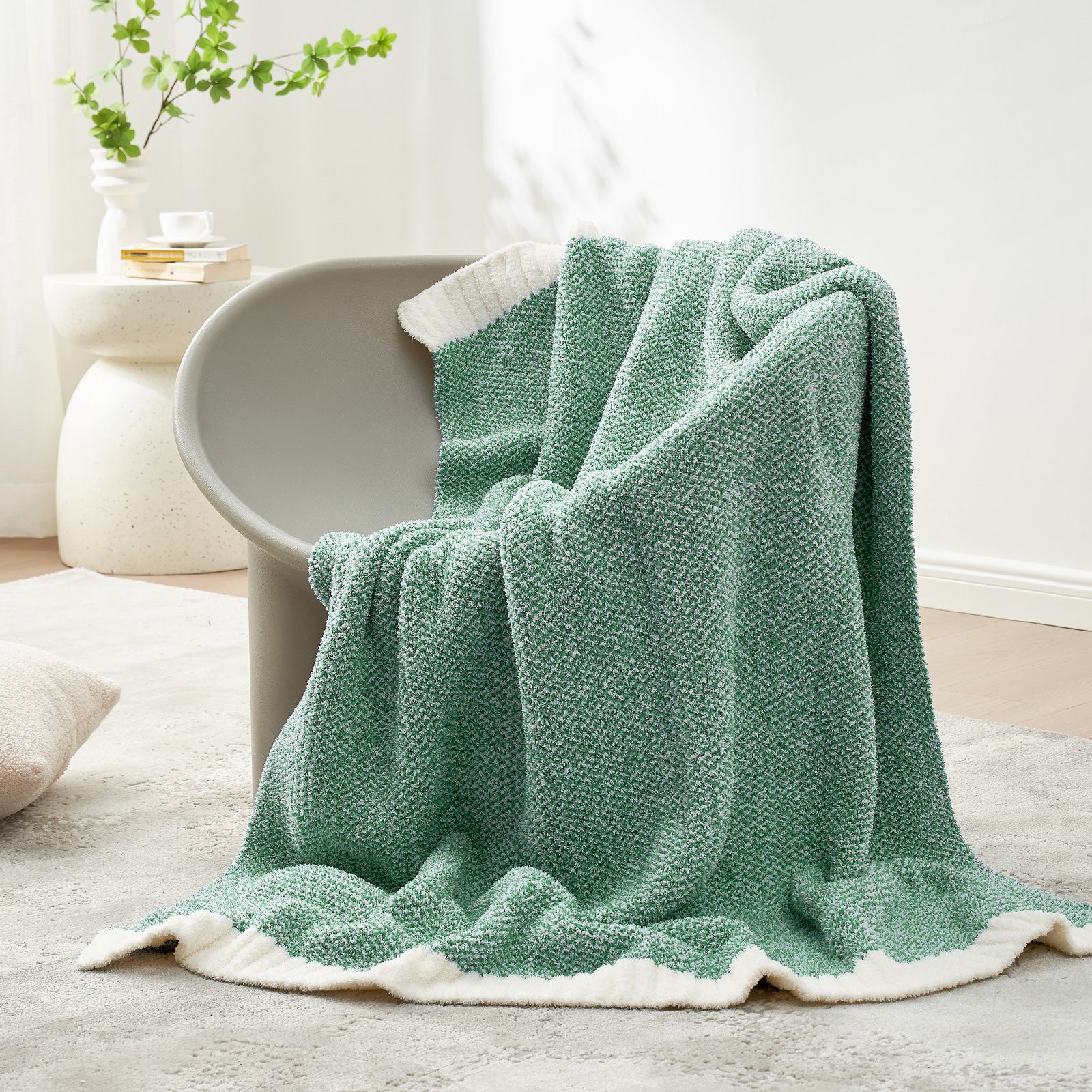 Green textured blanket draped over a chair in a cozy living room setting. #Color_Heather Green