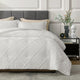 Snuggle Sac All-Season Jacquard Windowpane Comforter Set in off white on bed in a bedroom with plants and furnitures#color_Off White