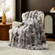 Snuggle Sac bubble faux fur electric blanket in Tie-dye Taupe draped over a chair with controller, creating a warm and cozy setting #color_Tie-dye Taupe