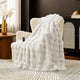 Snuggle Sac bubble faux fur electric blanket in Cream White draped over a chair with controller, creating a warm and cozy setting #color_Cream White