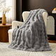 Snuggle Sac bubble faux fur electric blanket in Light Grey draped over a chair with controller, creating a warm and cozy setting #color_Light Grey