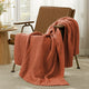 Snuggle Sac chevron chenille knit throw blanket in Burnt Orange casually draped over a chair in a cozy setting #color_Burnt Orange