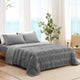 Snuggle Sac Cooling comforter in dark grey on bed in a bedroom with windows,plant and a view behind
#color_Dark Grey