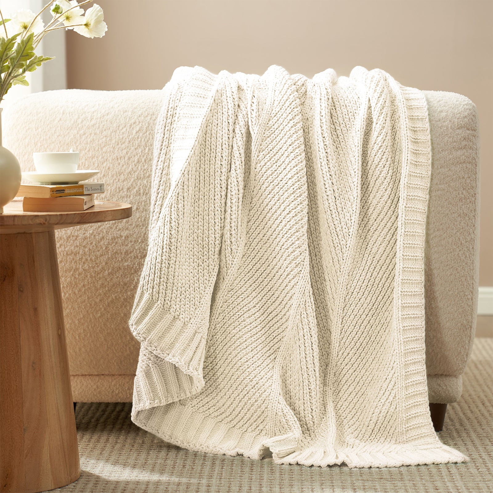 Chevron chenille knit throw blanket in Ivory draped over a sofa creating a warm and inviting look #color_Ivory
