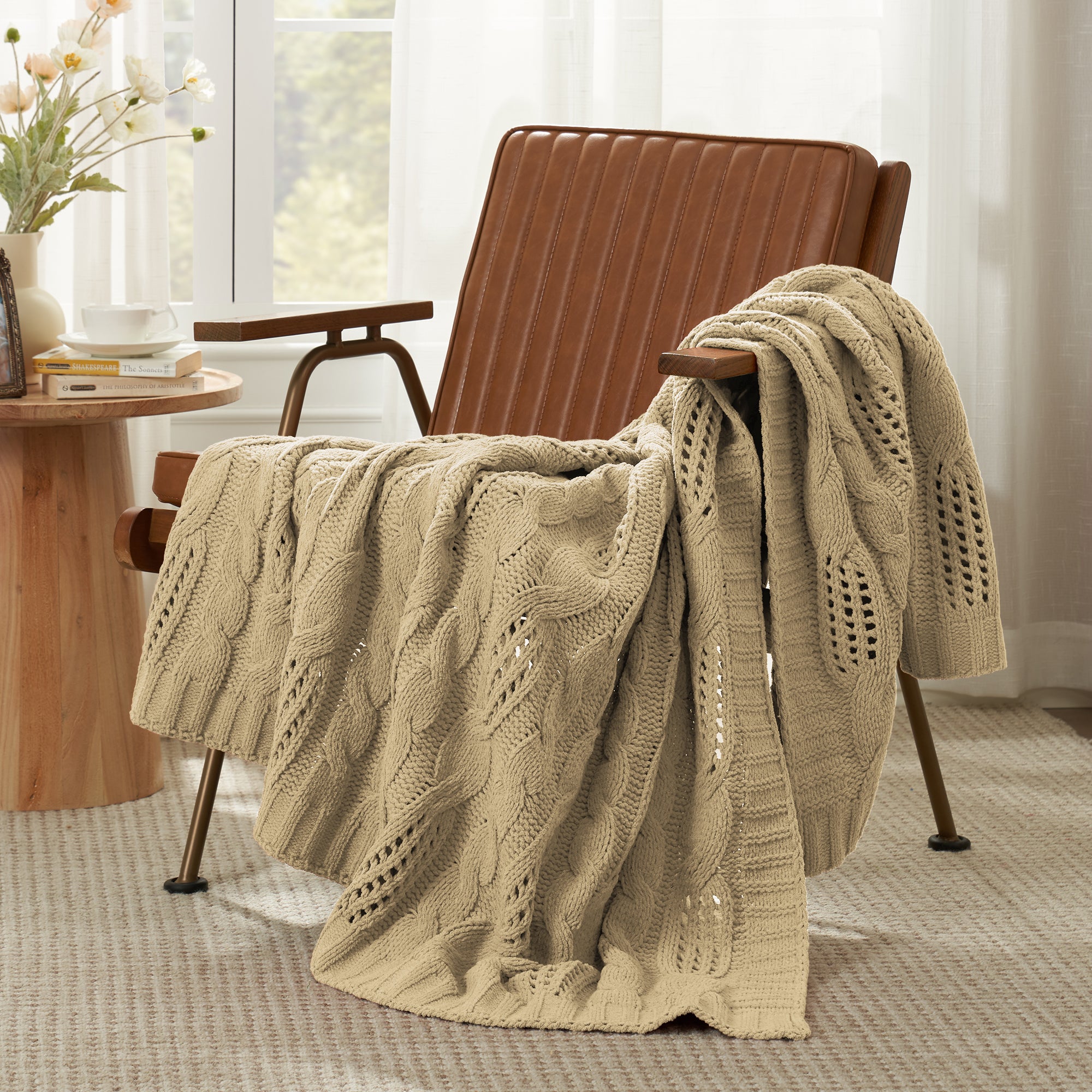 Snuggle Sac cable chenille knit throw blanket in Beige draped over a chair creating a cozy corner #color_Beige