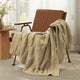 Snuggle Sac cable chenille knit throw blanket in Beige draped over a chair creating a cozy corner #color_Beige