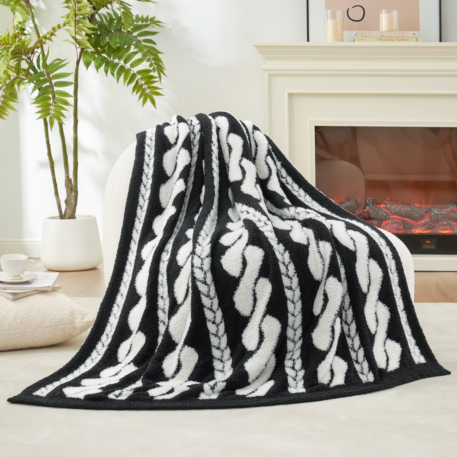 Cable pattern Faux Fur Knit Throw Blanket in black and white showing the front side.#color_Black