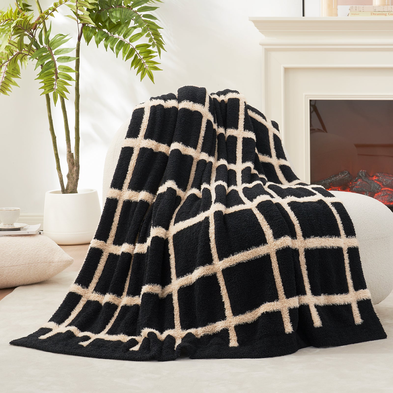 Black and white checkered faux fur Knit throw blanket draped over a sofa in a living room setting.#color_Black