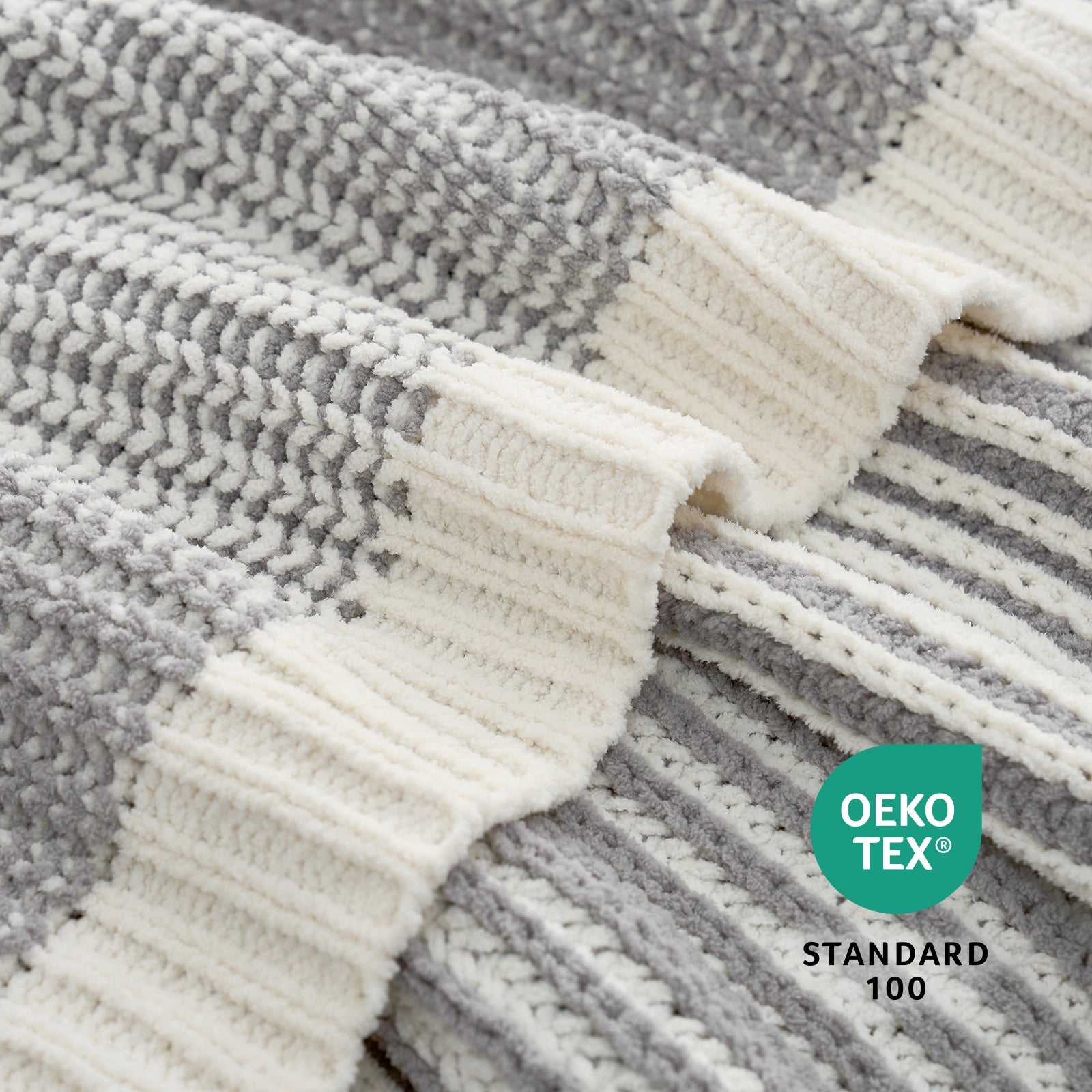 Textured fabric with grey and white stripes and a visible OEKO-TEX Standard 100 logo. #color_Two-tone Grey
