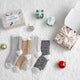 Snuggle Sac women heather plain socks 4 pairs in Mixed displayed in a cozy holiday gift setting #color_Khaki/Black/White/Grey