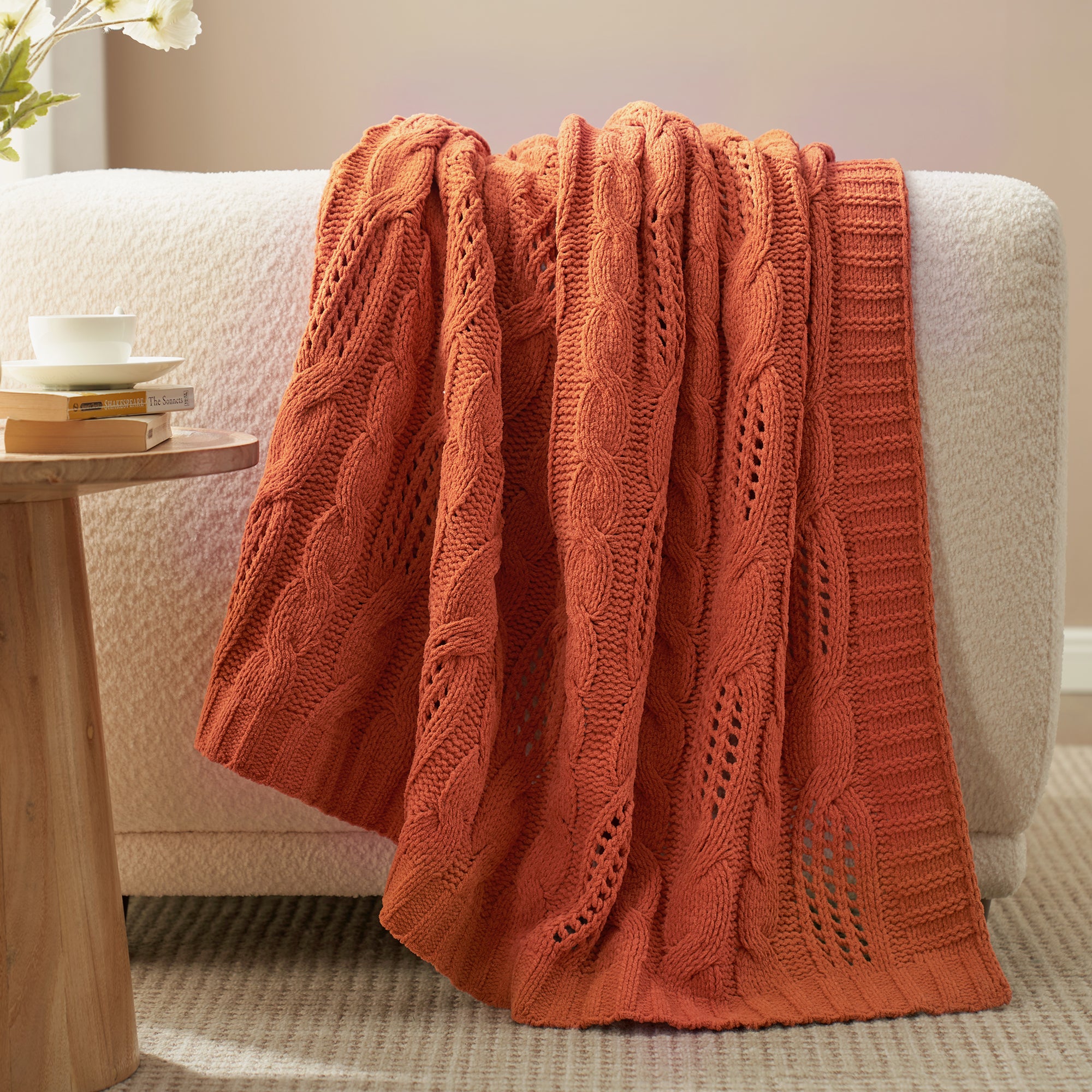 Cable chenille knit throw blanket in Burnt Orange draped over sofa creating an elegant home decor #color_Burnt Orange