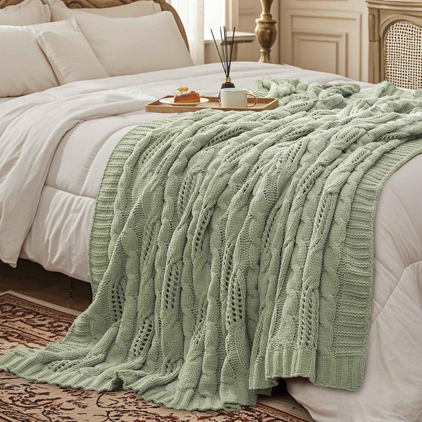 Cable chenille knit throw blanket in Sage Green layered on a bed creating a warm and cozy bedroom look #color_Sage Green