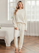 Snuggle Sac women long sleeve crewneck knit loungewear set in Ivory, styled in a cozy bedroom setting with a relaxed and comfortable fit #color_Ivory