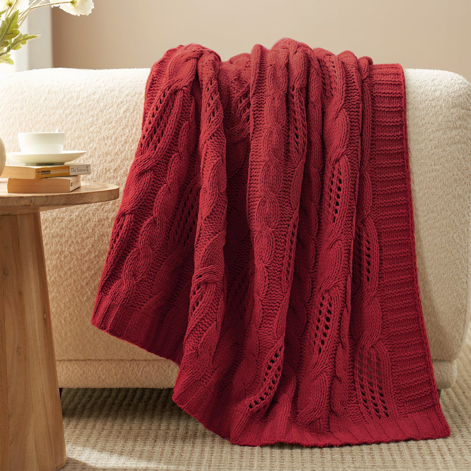 Cable chenille knit throw blanket in Red draped over sofa creating an elegant home decor #color_Red