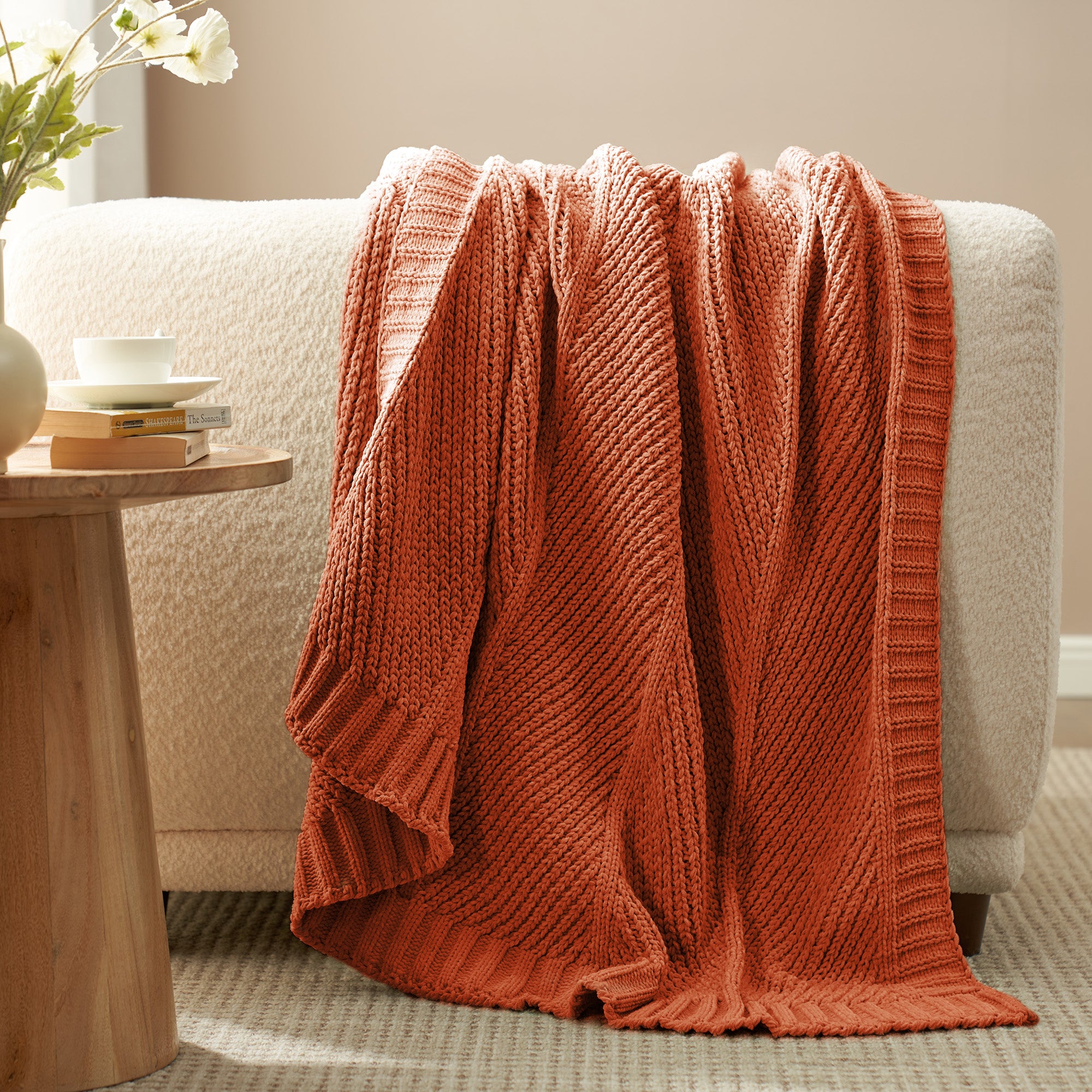 Chevron chenille knit throw blanket in Burnt Orange draped over a sofa creating a warm and inviting look #color_Burnt Orange