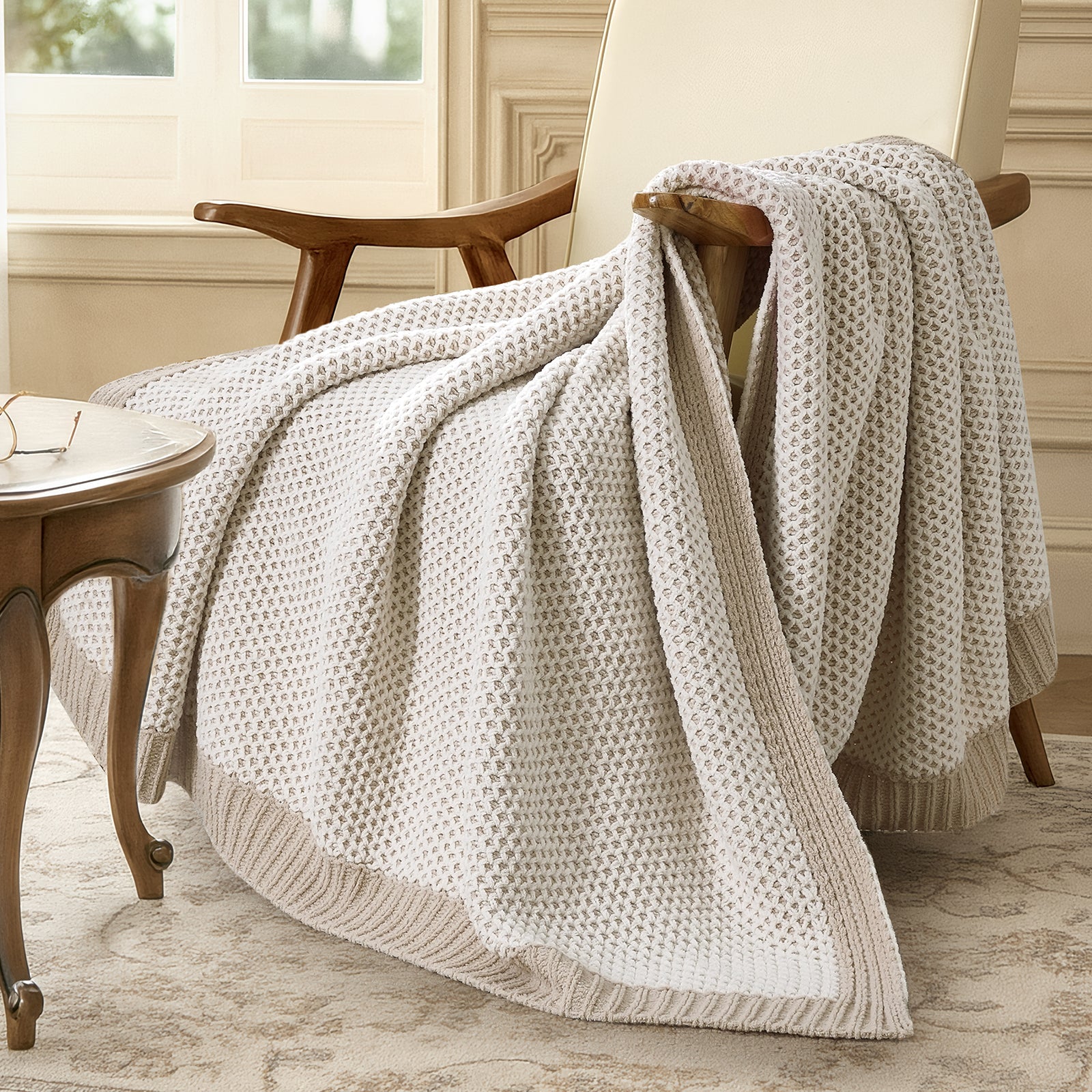 Snuggle Sac Beige textured throw blanket draped over a wooden chair in a cozy room. #color_Khaki&White