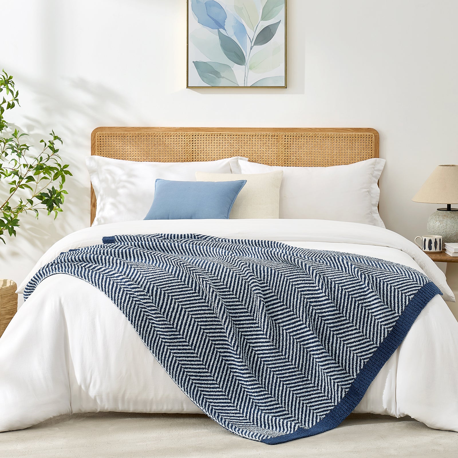 Snuggle Sacs Herringbone Feather Yarn Knit Throw Blanket on the bed with furnitures and plant#color_Navy