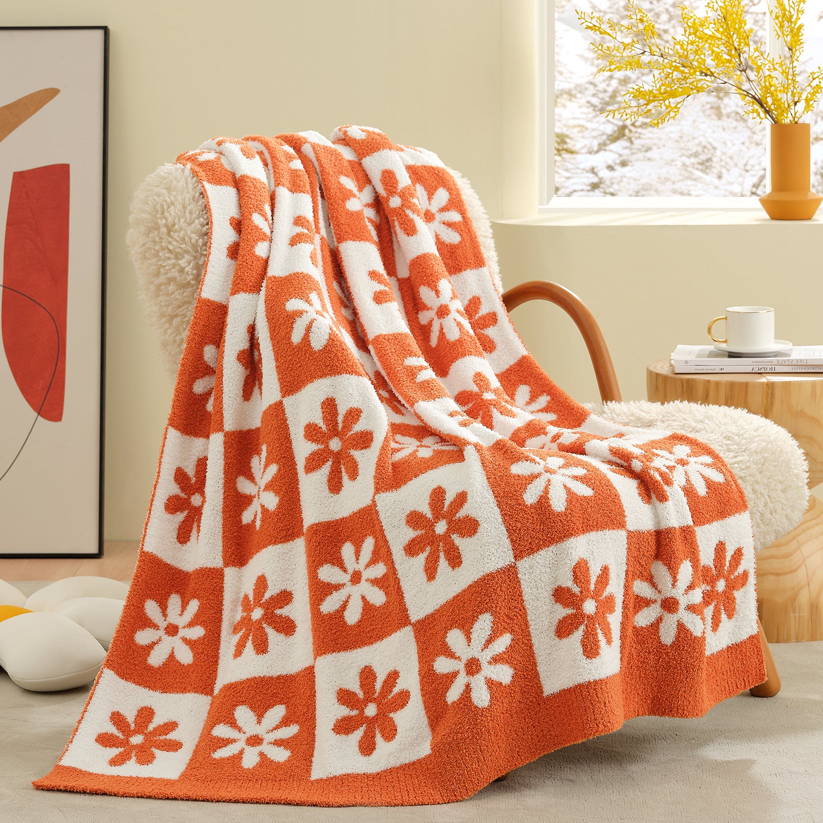 Orange and white patterned blanket draped over a chair in a cozy living room. #color_Orange
