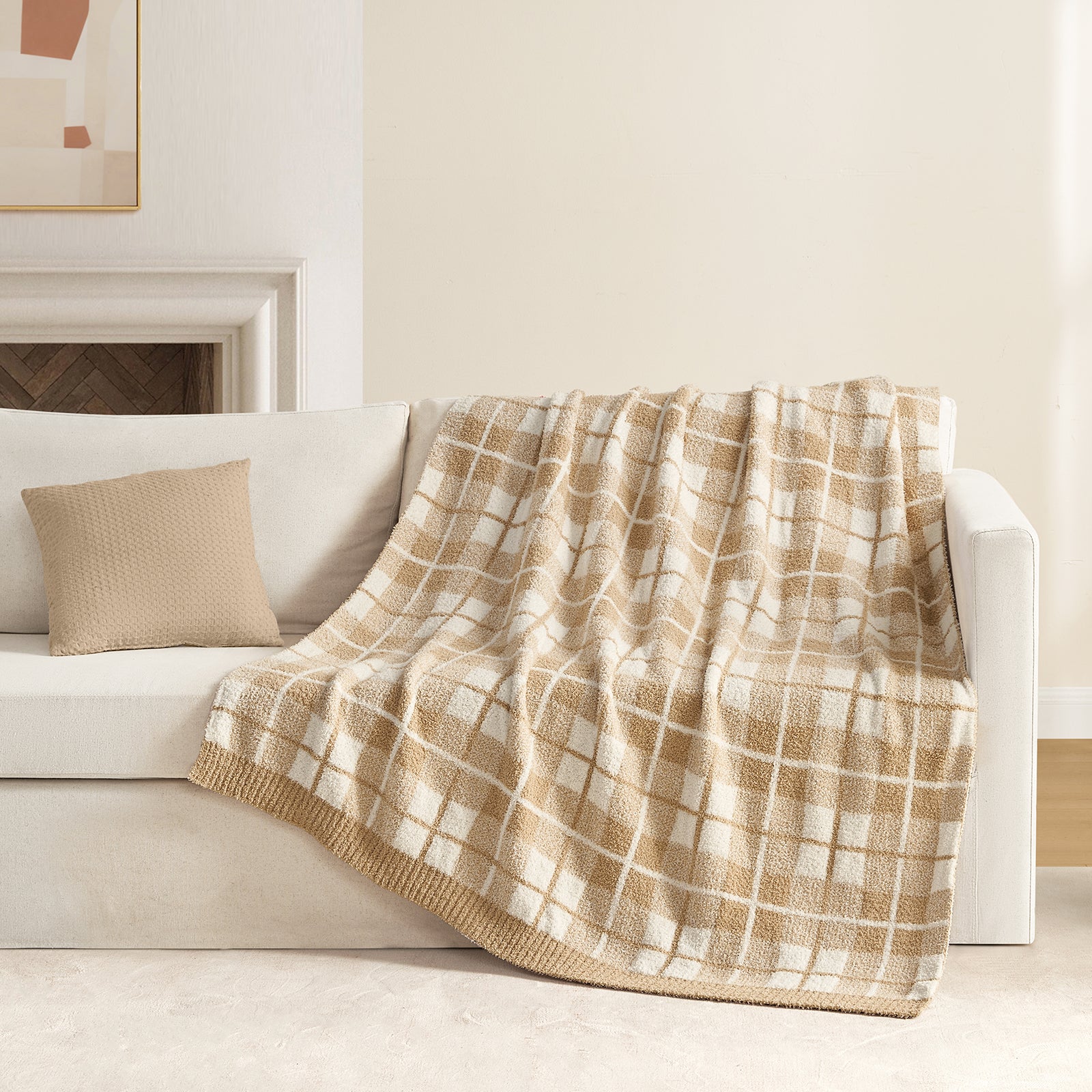 Reversible Buffalo Plaid Feather Yarn Knit Throw Blanket draped over a beige sofa with fireplace behind#Color_Plaid Beige