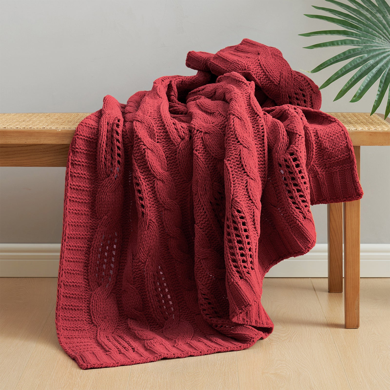 Snuggle Sac cable chenille knit throw blanket in Red draped over a chair creating a cozy corner #color_Red