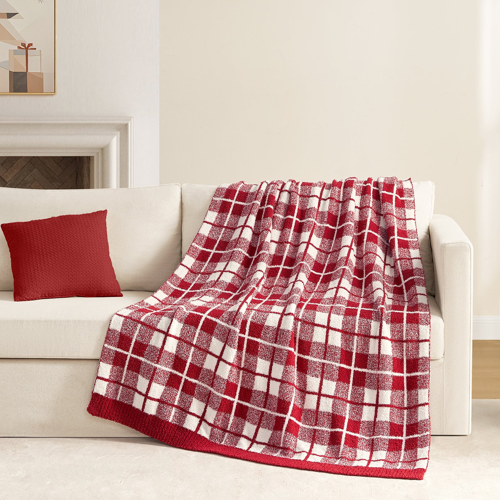 Reversible Buffalo Plaid Feather Yarn Knit Throw Blanket draped over a beige couch with fireplace behind#Color_Red