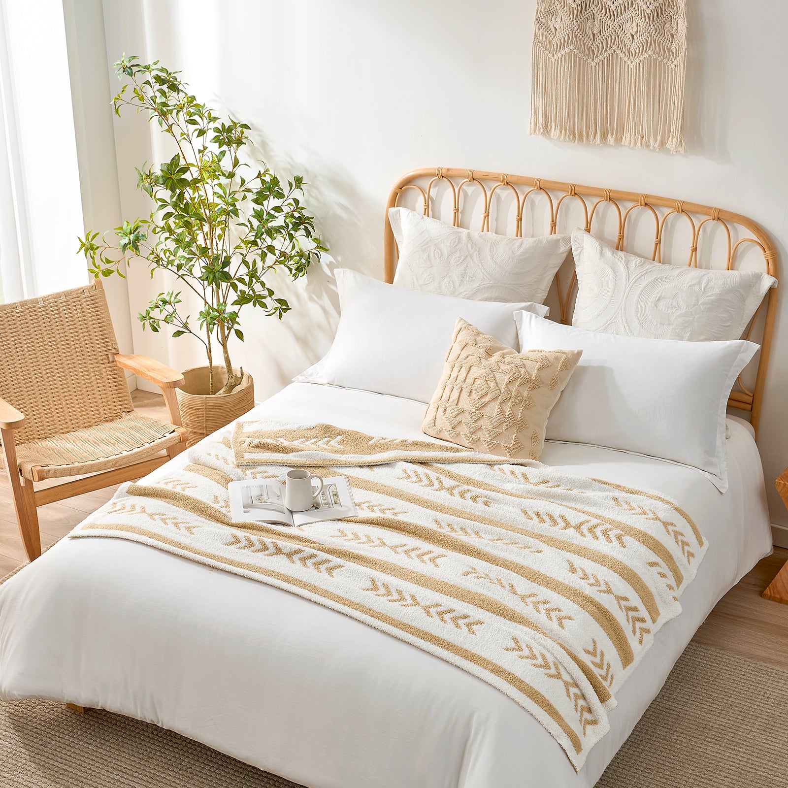 Snuggle Sacs Reversible Boho Feather Yarn Knit Throw Blanket on a bed with mug and magazine in a bright room with plant and furniture#color_beige