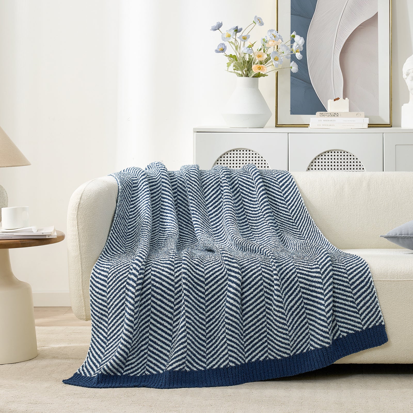 Snuggle Sacs Herringbone Feather Yarn Knit Throw Blanket on the couch with furnitures behind#color_Navy