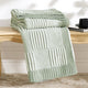 Snuggle Sac two tone checkered chenille knit throw blanket in Sage Green neatly folded on a wooden table #color_Sage Green