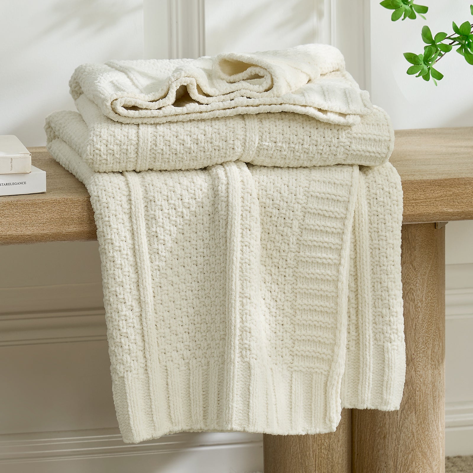 Stack of Ivory textured towels on a wooden surface with a neutral background #color_Ivory