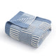Snuggle Sac folded blue and white textured blanket on a white background #color_Blue