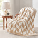 Snuggle Sacs Chevron Feather Yarn Knit Throw Blanket on the chair with lamp and window behind#color_Beige
