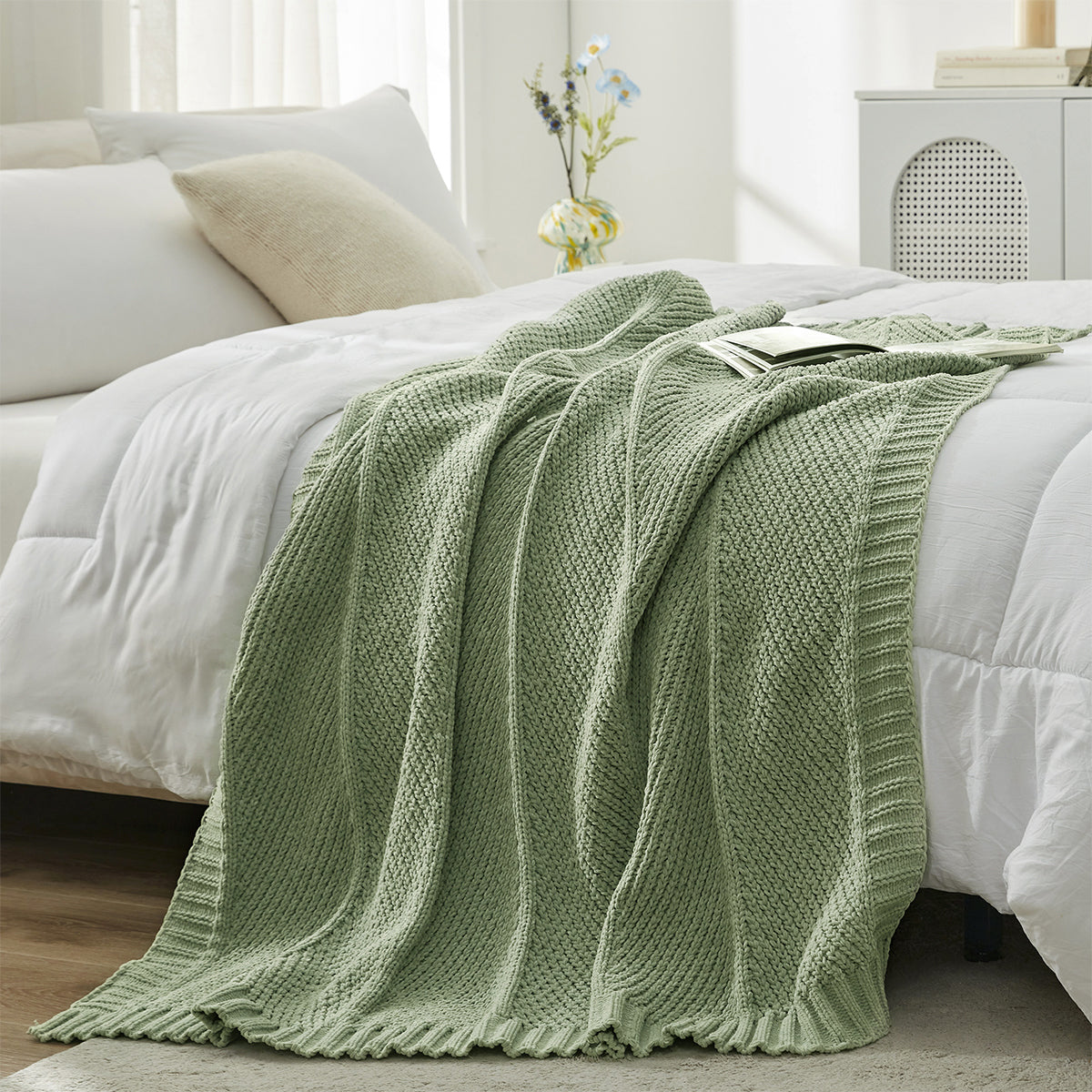 Chevron chenille knit throw blanket in Sage Green layered on bed creating a soft and cozy bedroom look #color_Sage Green