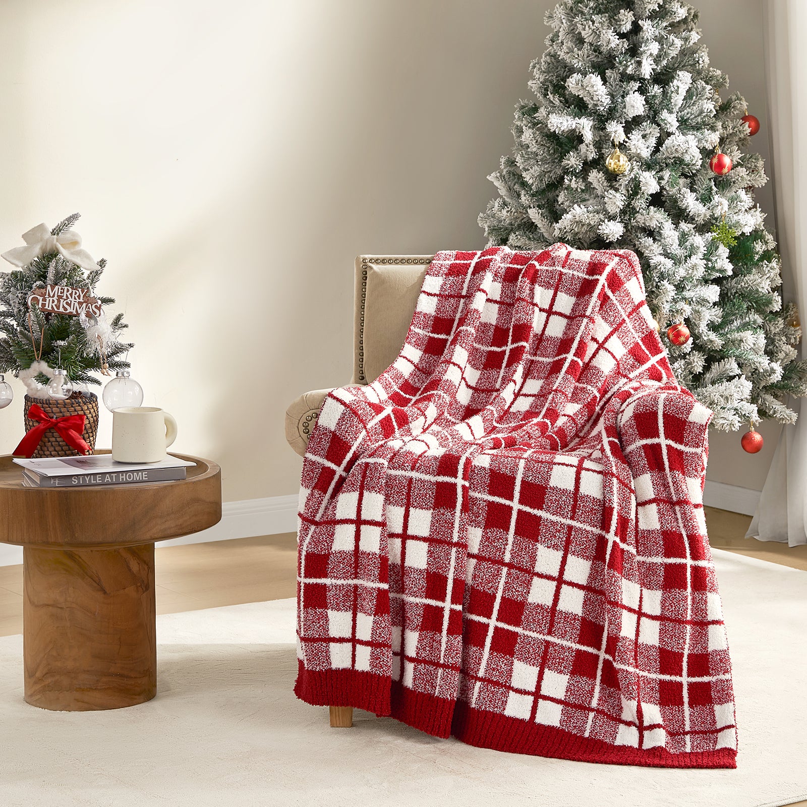 Reversible Buffalo Plaid Feather Yarn Knit Throw Blanket draped over a brown chair with christmas tree and decorations around the room#Color_Red