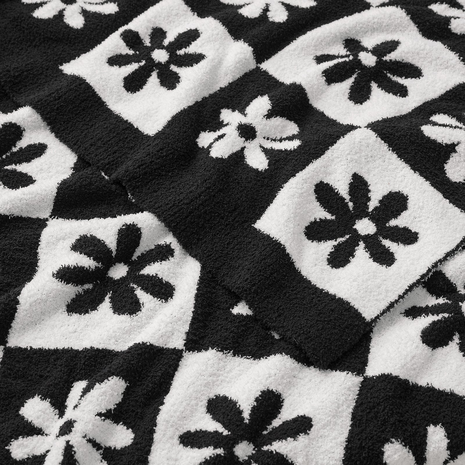 Black and white checkered blanket with floral patterns #color_Black