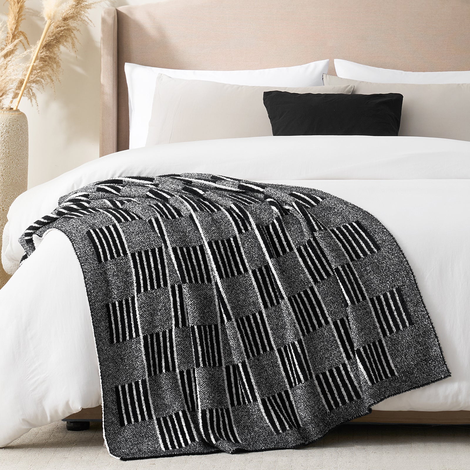 Gray patterned blanket on a bed with white bedding and pillows.  #color_Heather Black