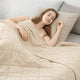 Woman sleeping under a Snuggle Sac khaki comforter in a cozy bedroom setting.   #color_Khaki